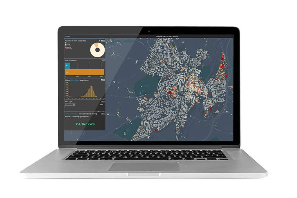 Open laptop displaying a geospatial analysis platform with a map visualisation, showcasing solar suitability data, potential system size, roof types, and electricity savings metrics. The interface uses LiDAR and DSM technology to optimise solar panel placement for urban areas, highlighting renewable energy potential and sustainable planning.